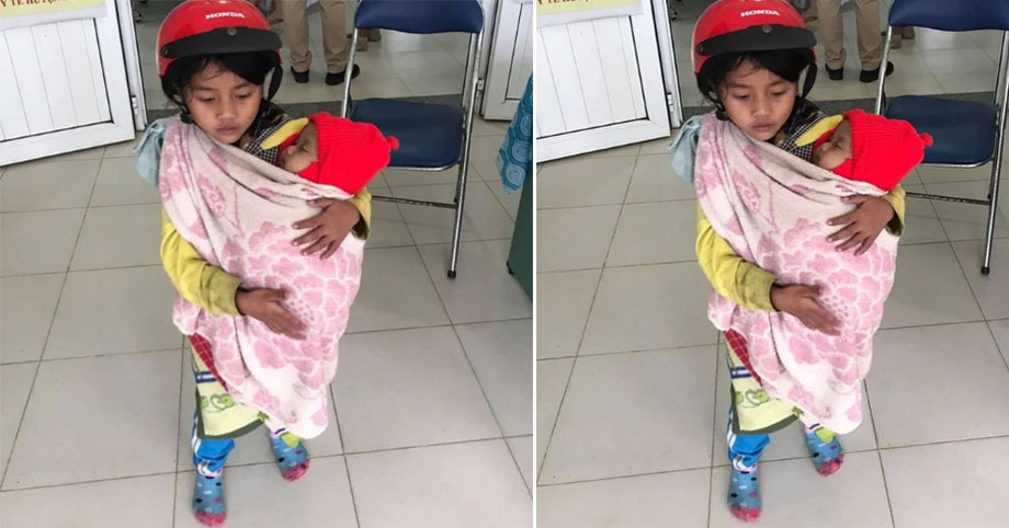 Hình ảnh chị 7 tuổi địu em 5 tháng tuổi đi tiêm phòng đi tiêm phòng gây “sốt” mạng xã hội